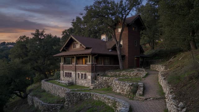 A distinctive hillside Craftsman on a steep Pasadena lot at dusk